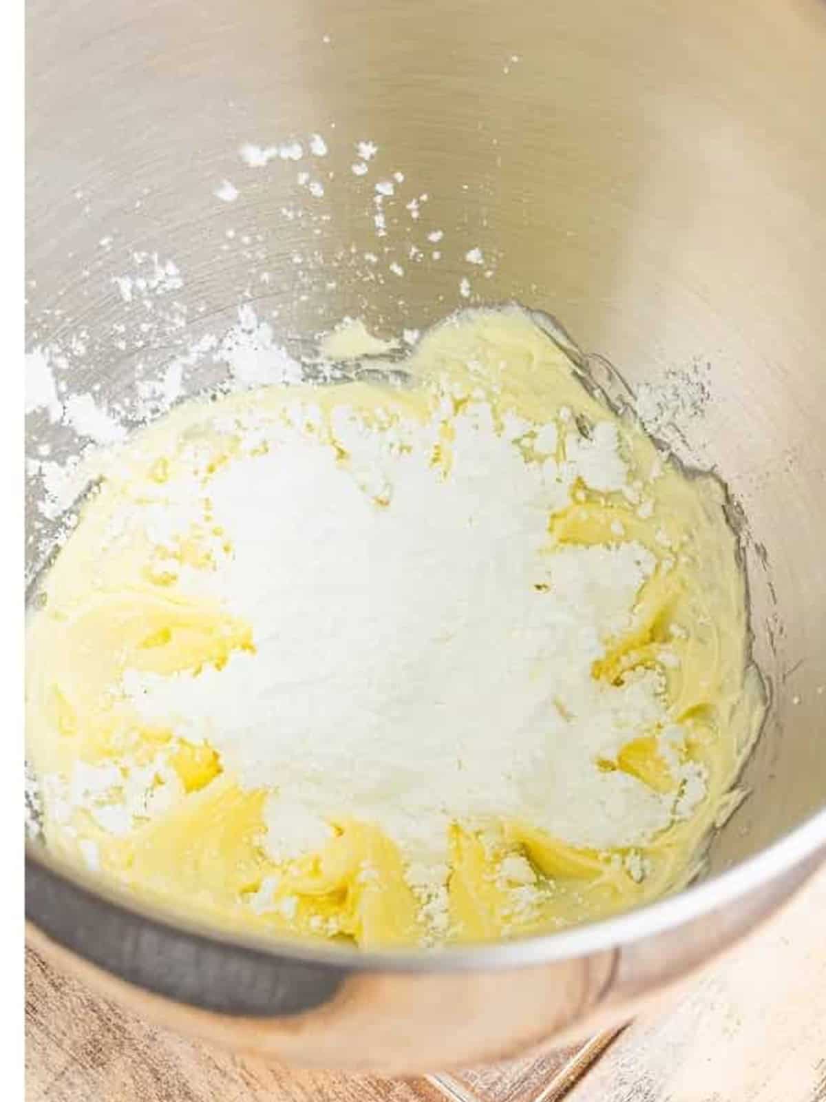 Whipping butter and powdered sugar for the blueberry frosting.