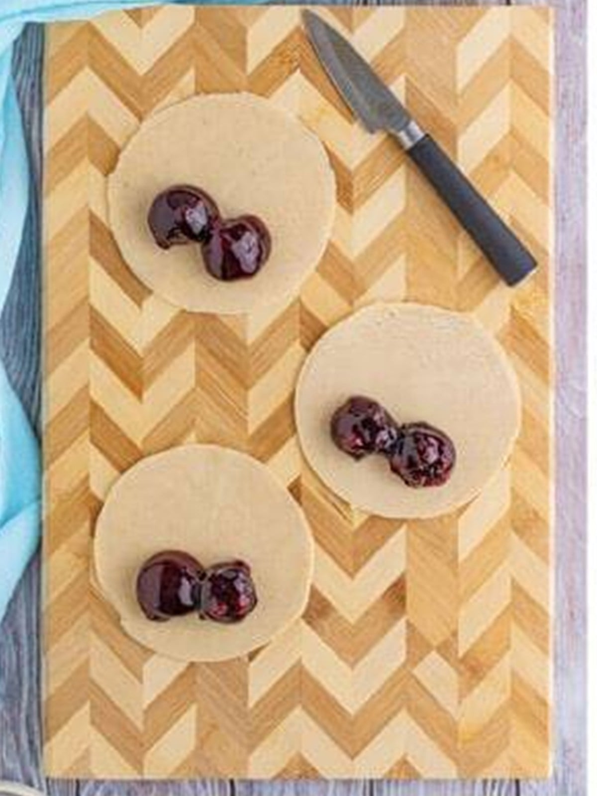Pie crust circles cut out with blueberry pie filling spooned on top.