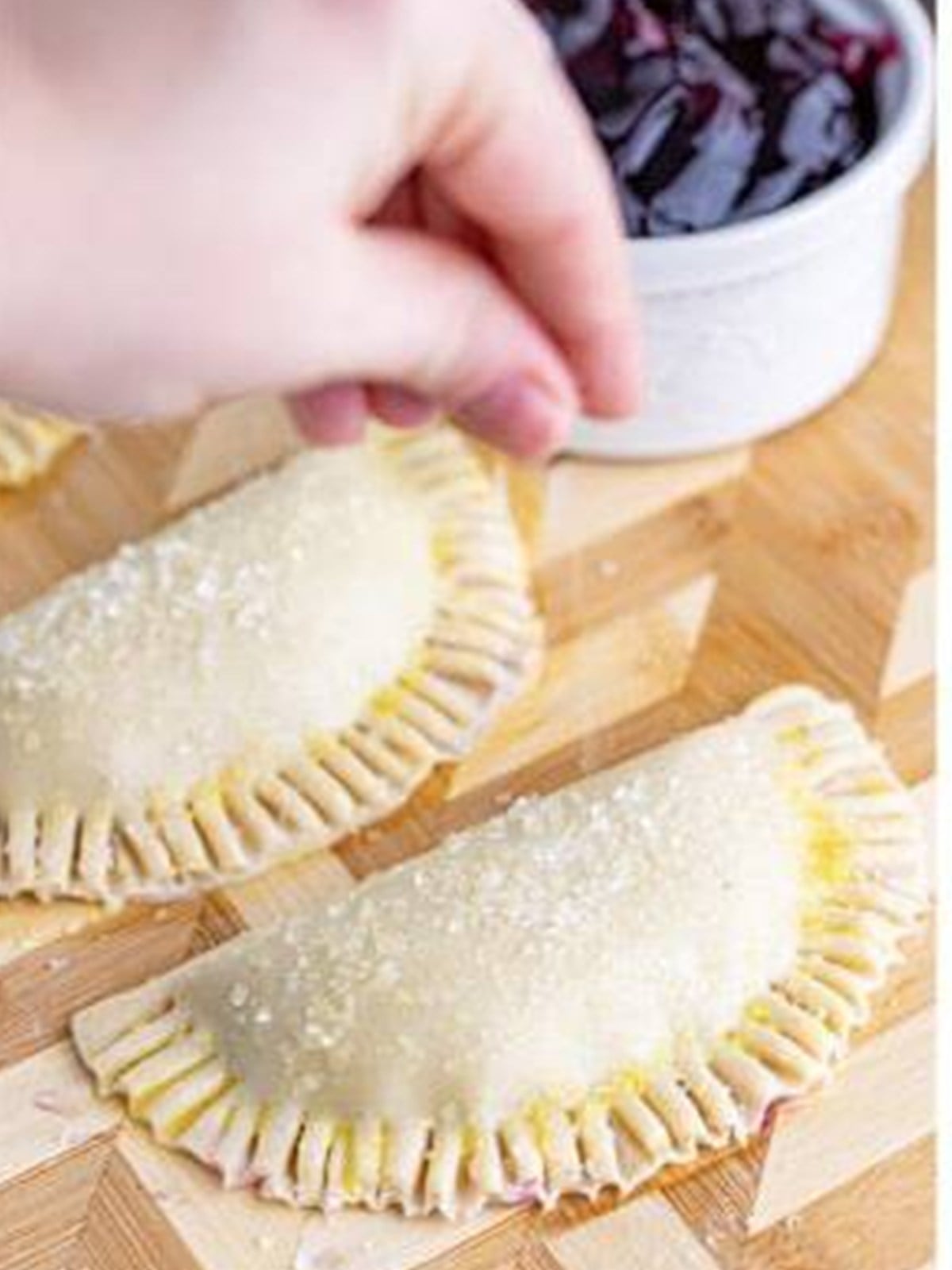 Decorators sugar sprinkled over the hand pies.