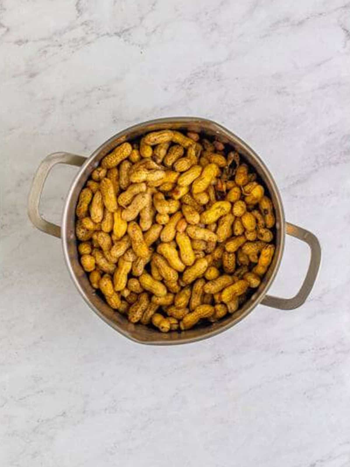 Rinsed raw peanuts ready in the stockpot before seasoning.
