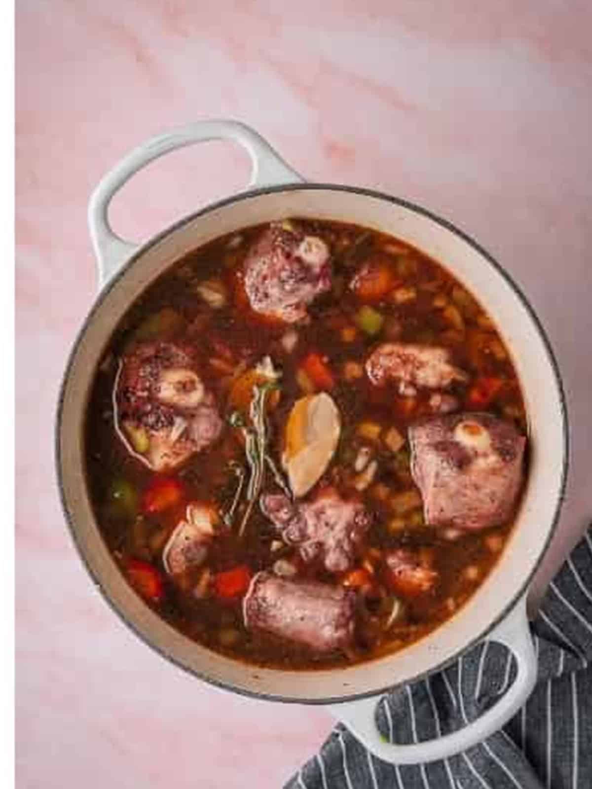 Fall off the bone braised oxtails in a rich gravy in a Dutch oven.