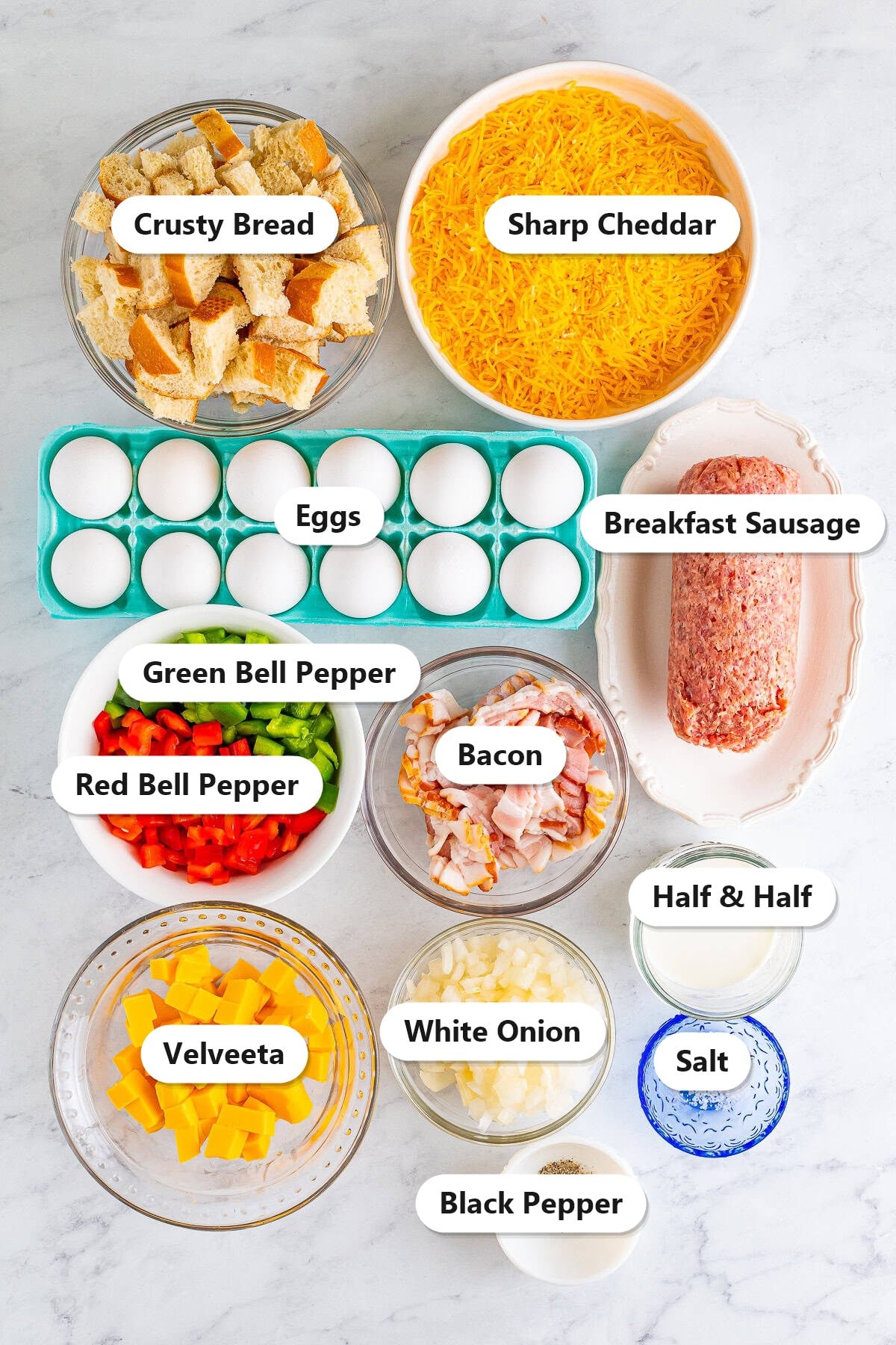 Breakfast casserole ingredients labeled on a marble counter