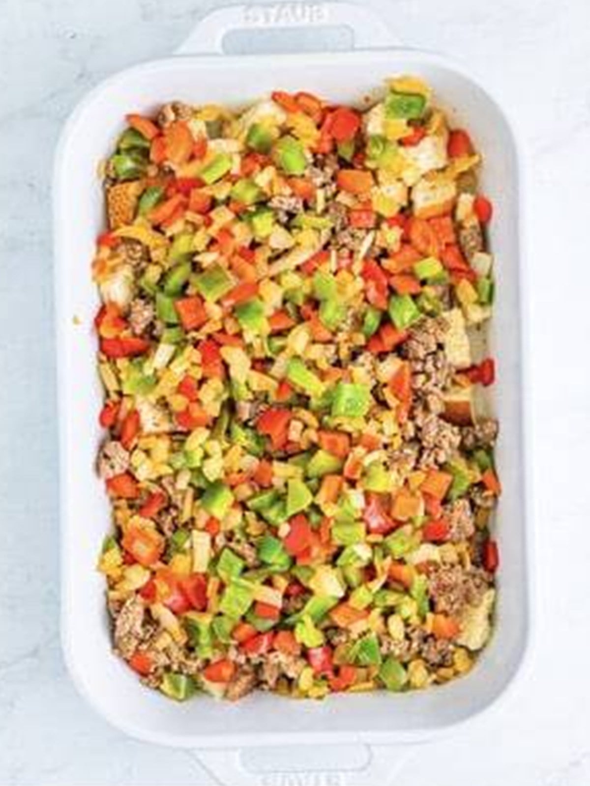 Diced peppers and onion layered in breakfast casserole