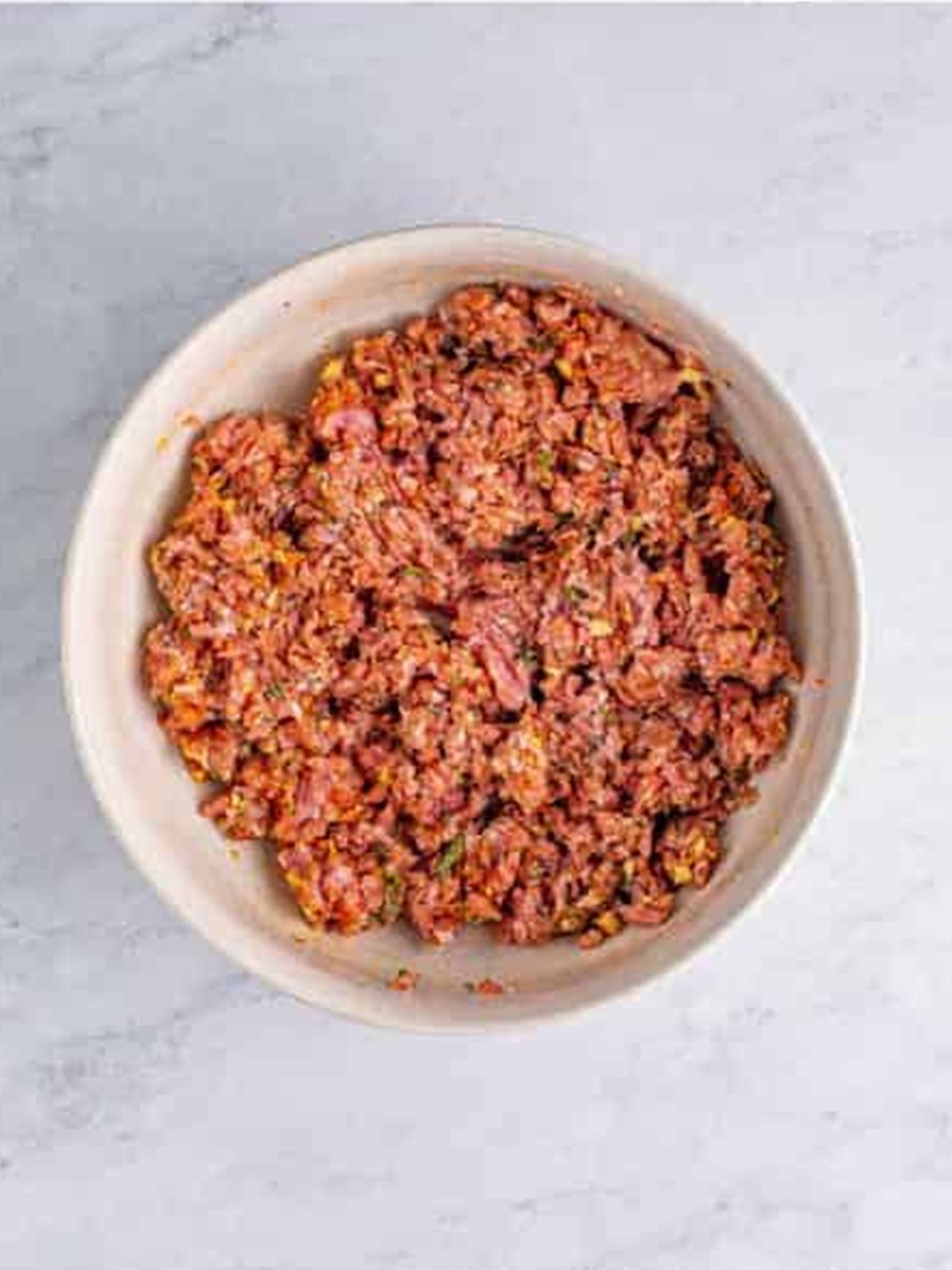 Breakfast sausage mixture combined and ready to chill in a bowl.