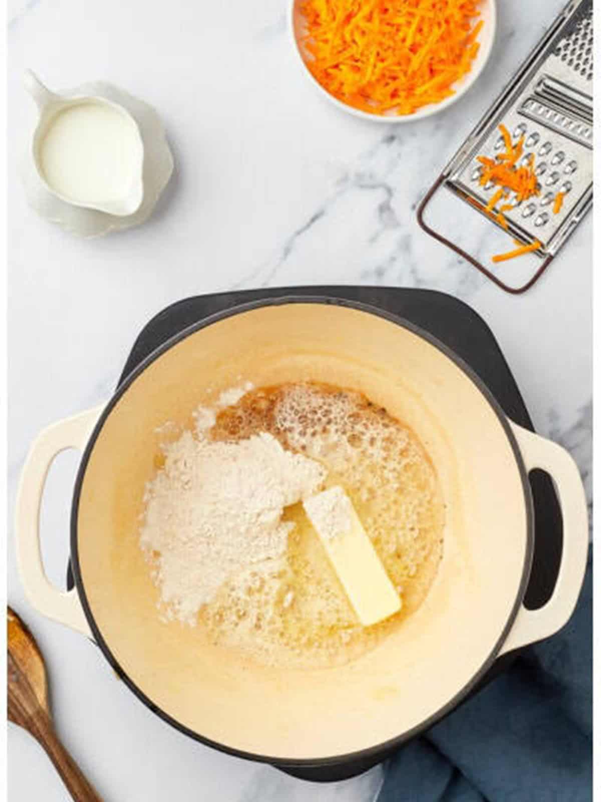 Butter and flour whisked into a roux in a pot.
