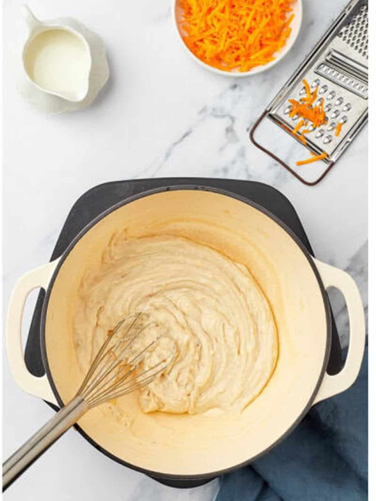 Milk whisked into the roux until smooth and thick.