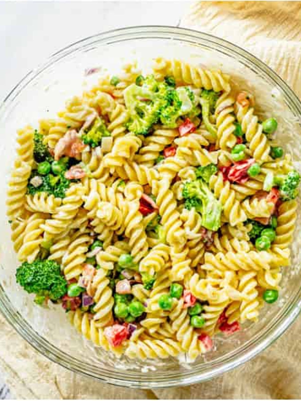 Broccoli pasta salad folded together with rotini and creamy dressing.