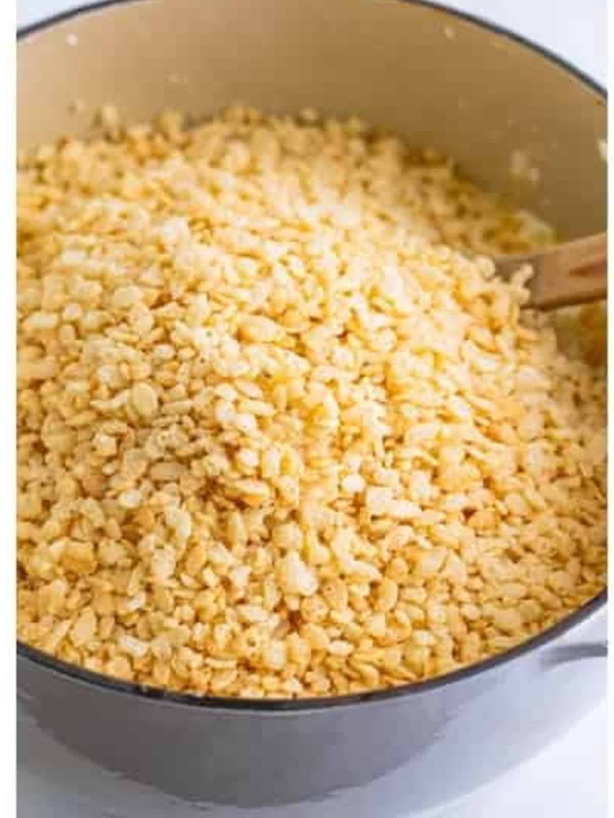 Rice Krispies cereal added to the melted marshmallow base in the pot.