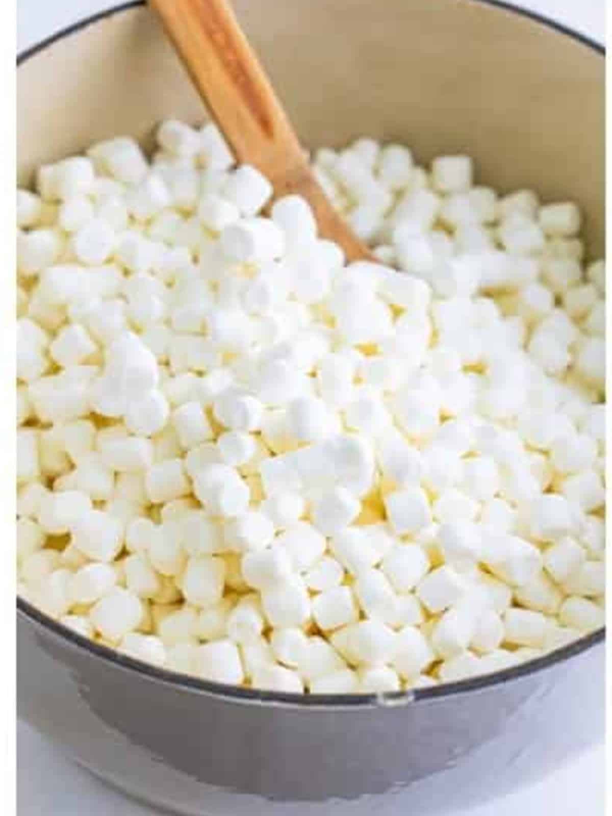 Mini marshmallows added to the browned butter in the pot for rice krispie treats.