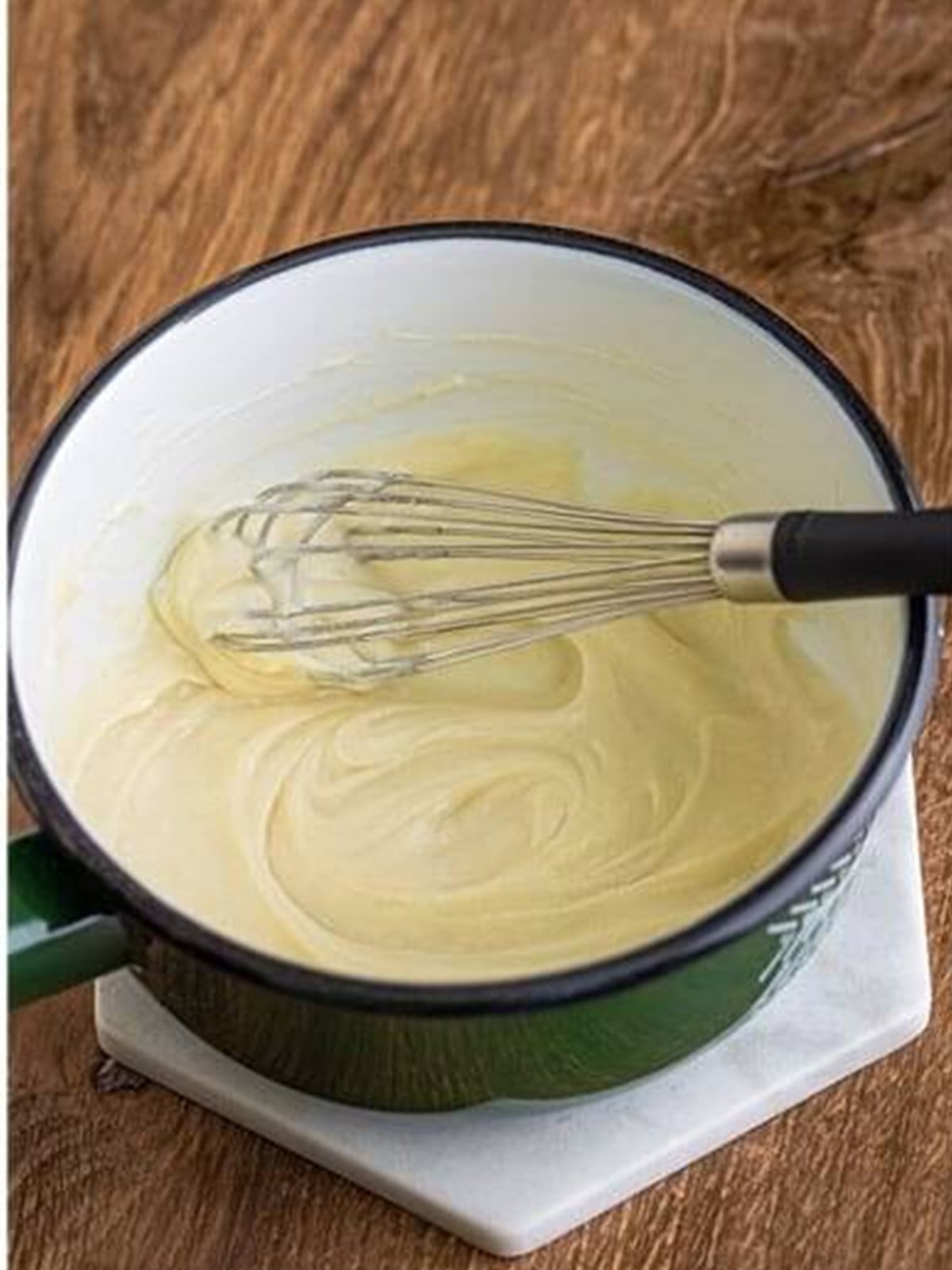Cooking the milk and flour paste until thick.