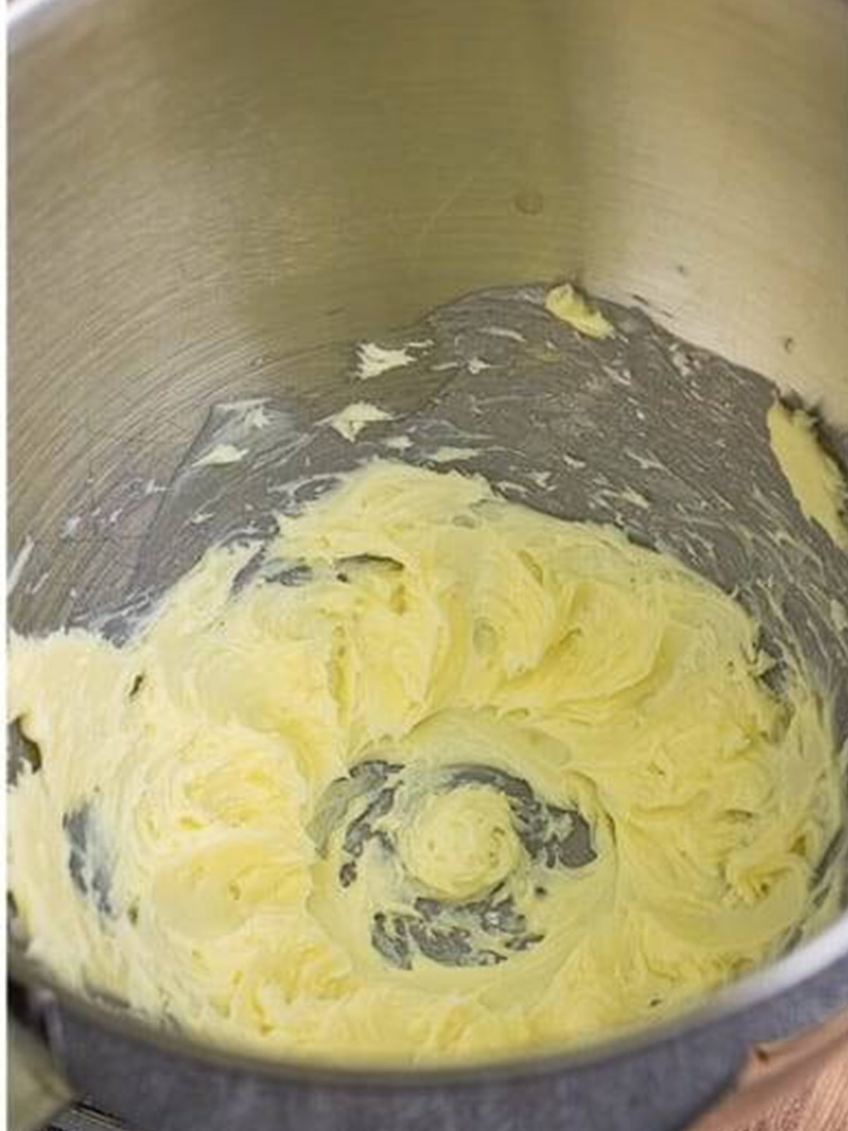 Whipping softened butter in a stand mixer.