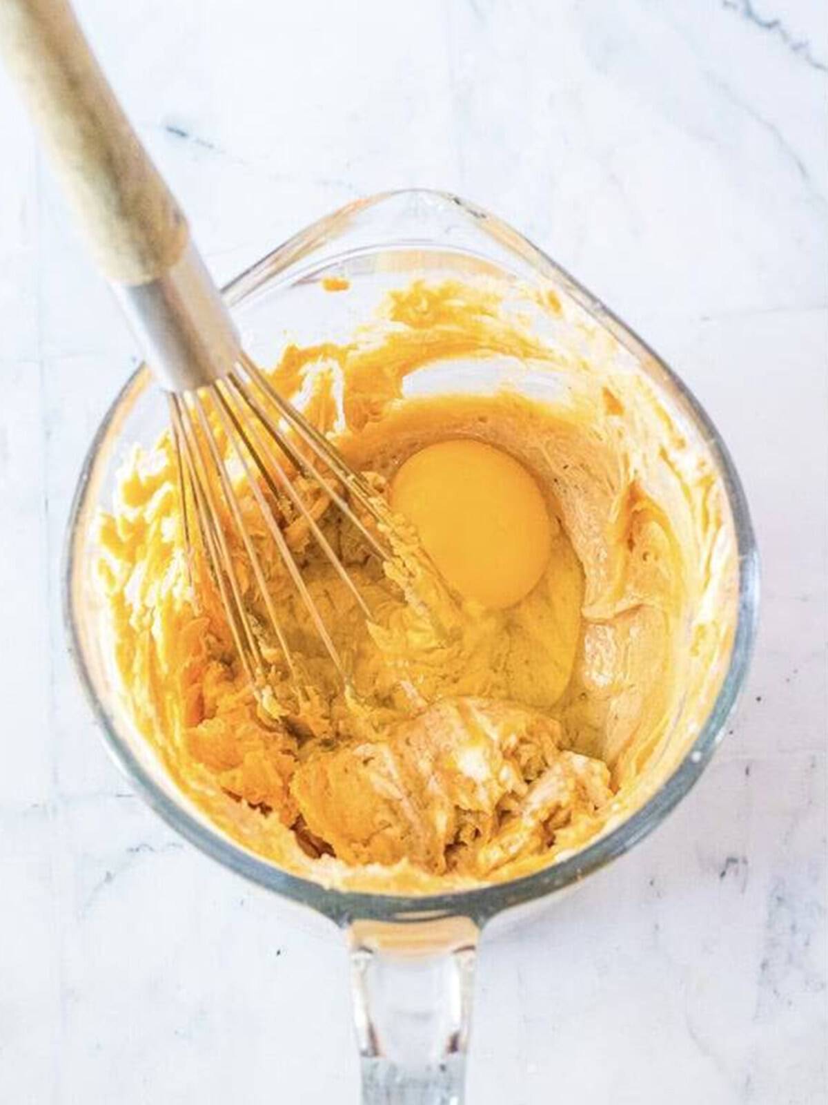 Peanut butter cream cheese filling whisked in a bowl for brownie cake.
