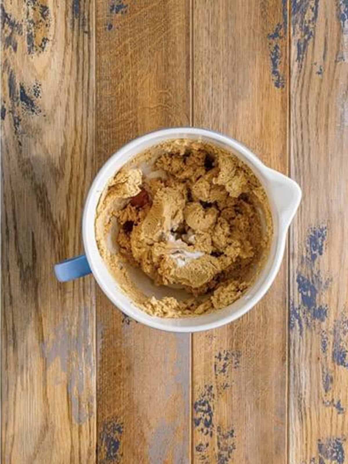 The peanut butter frosting mixed thick in the bowl.