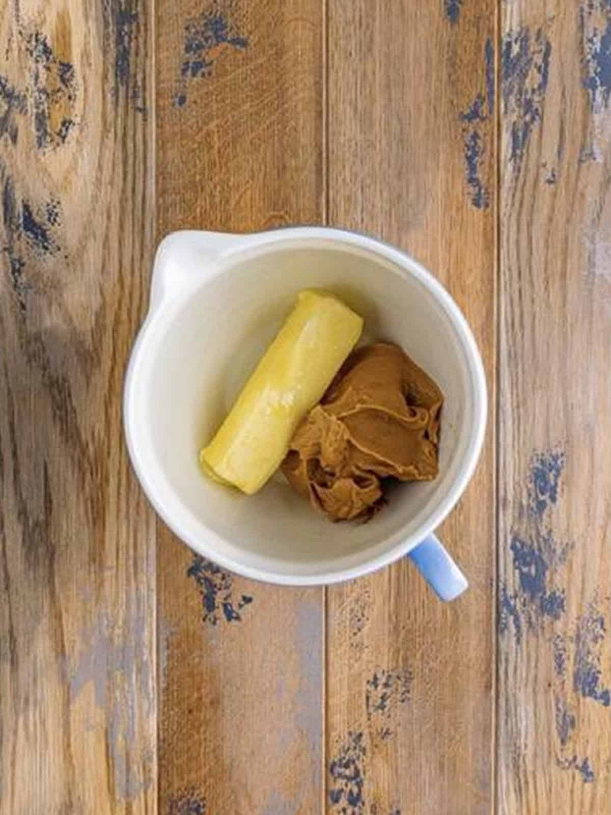 Peanut butter and butter in a mixing bowl for the frosting.