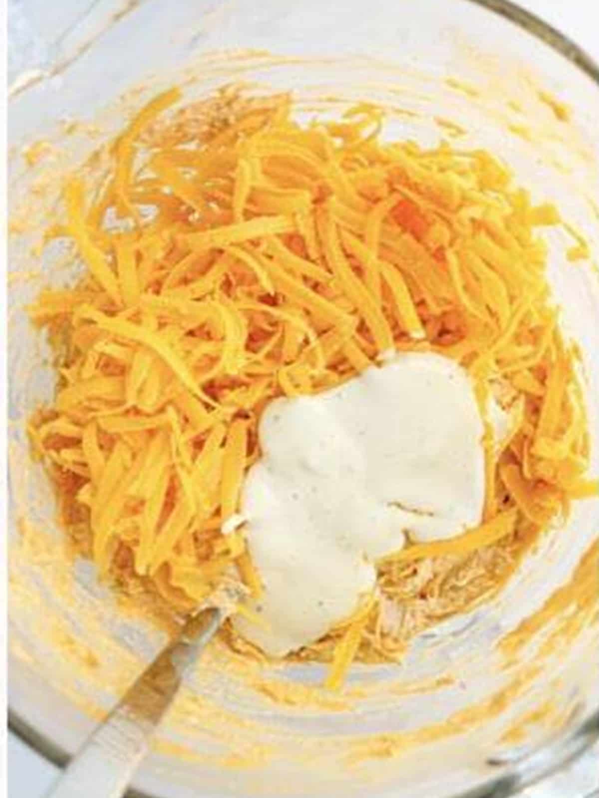 Shredded cheddar and ranch dressing added to the buffalo chicken filling.