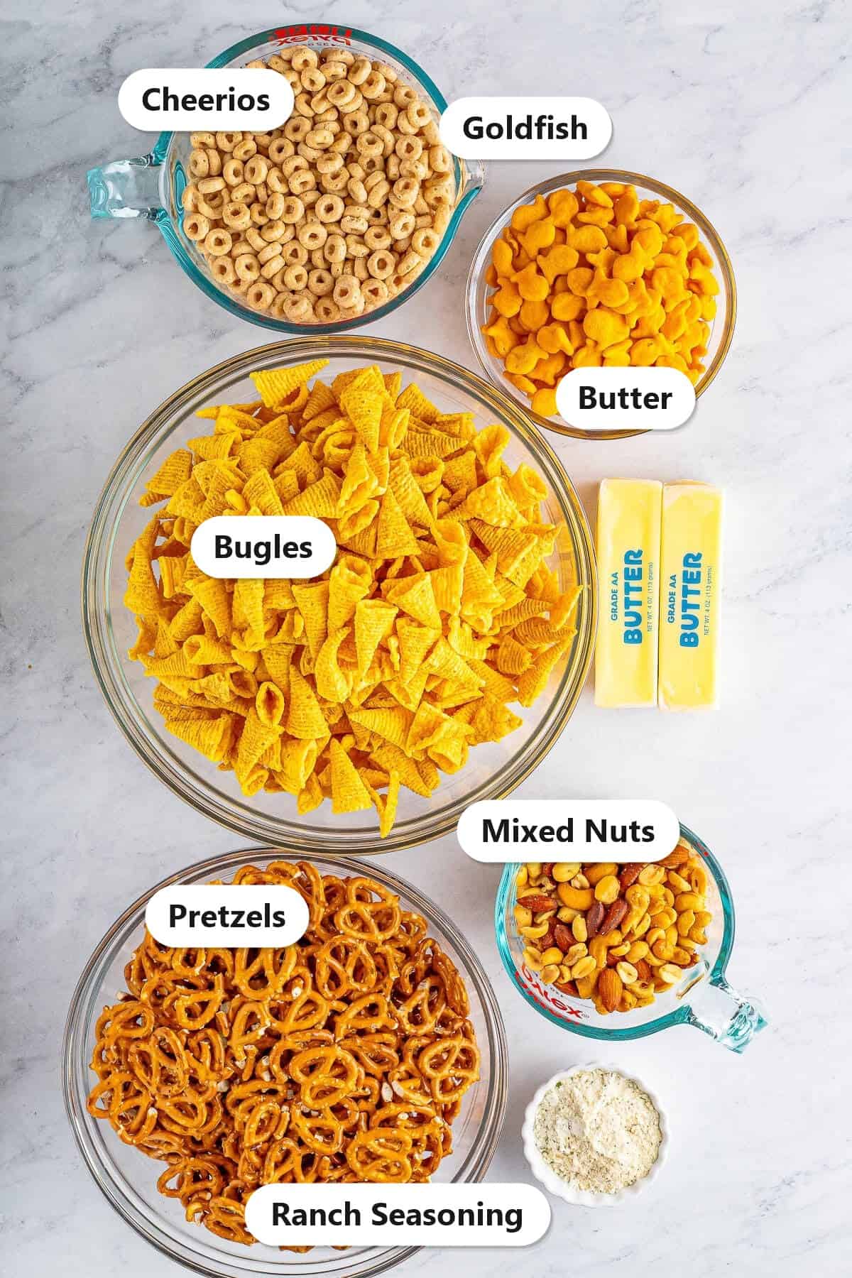 Labeled ingredients for Bugles ranch snack mix including Bugles, Cheerios, pretzels, mixed nuts, Goldfish, butter, and ranch seasoning.