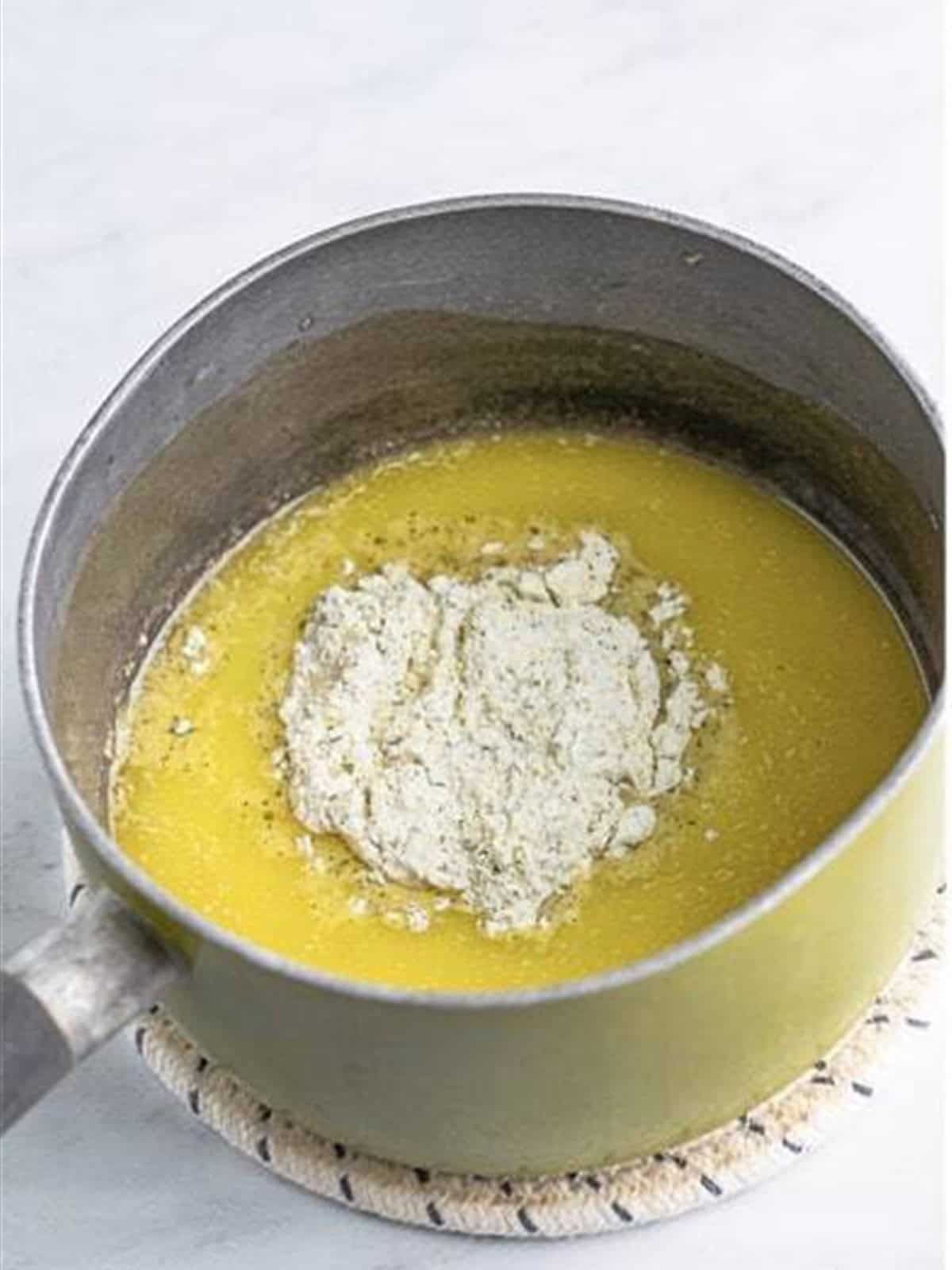 Melted butter and ranch seasoning combined in a saucepan.