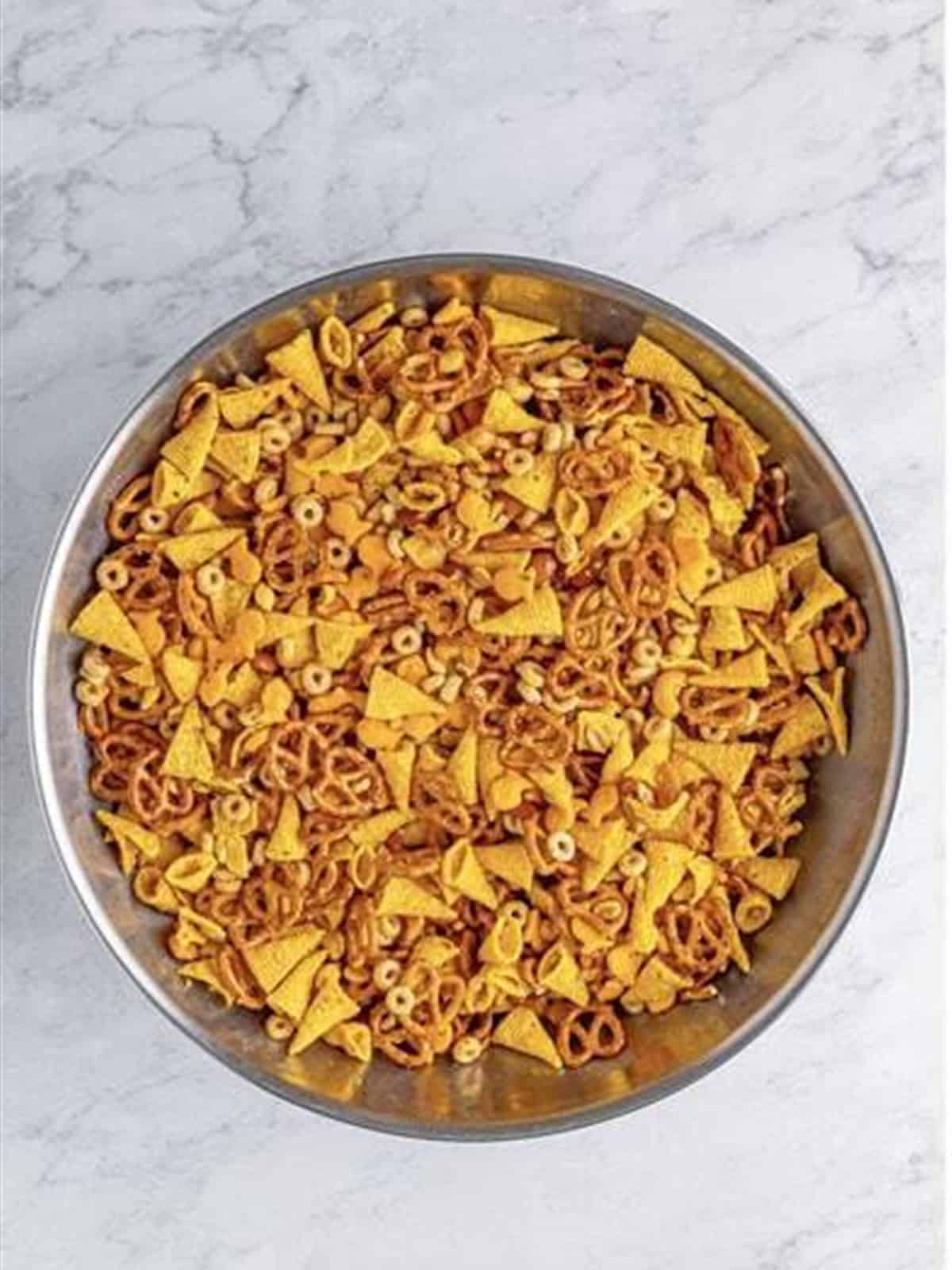 Snack mix tossed and evenly coated in the ranch butter.