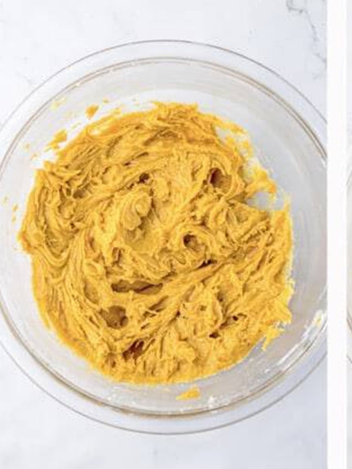 Smooth peanut butter cookie dough in a glass bowl.