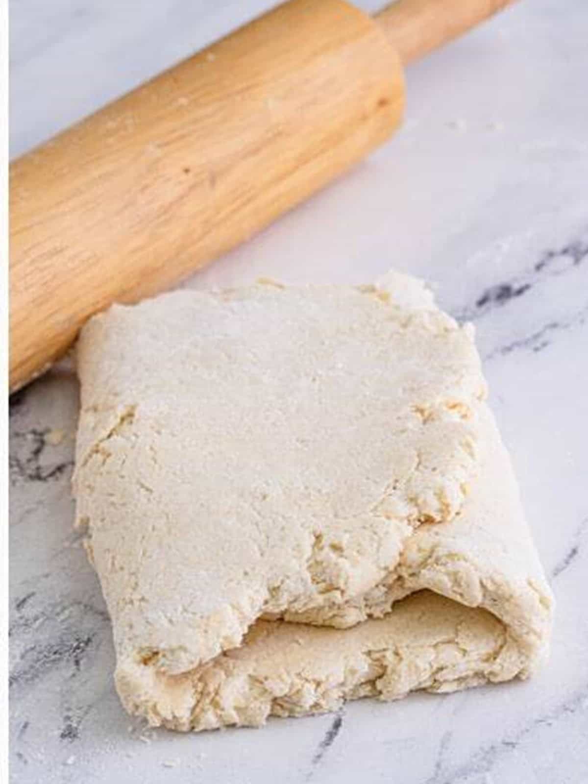 Folding the buttermilk biscuit dough in a tri-fold for flaky layers.