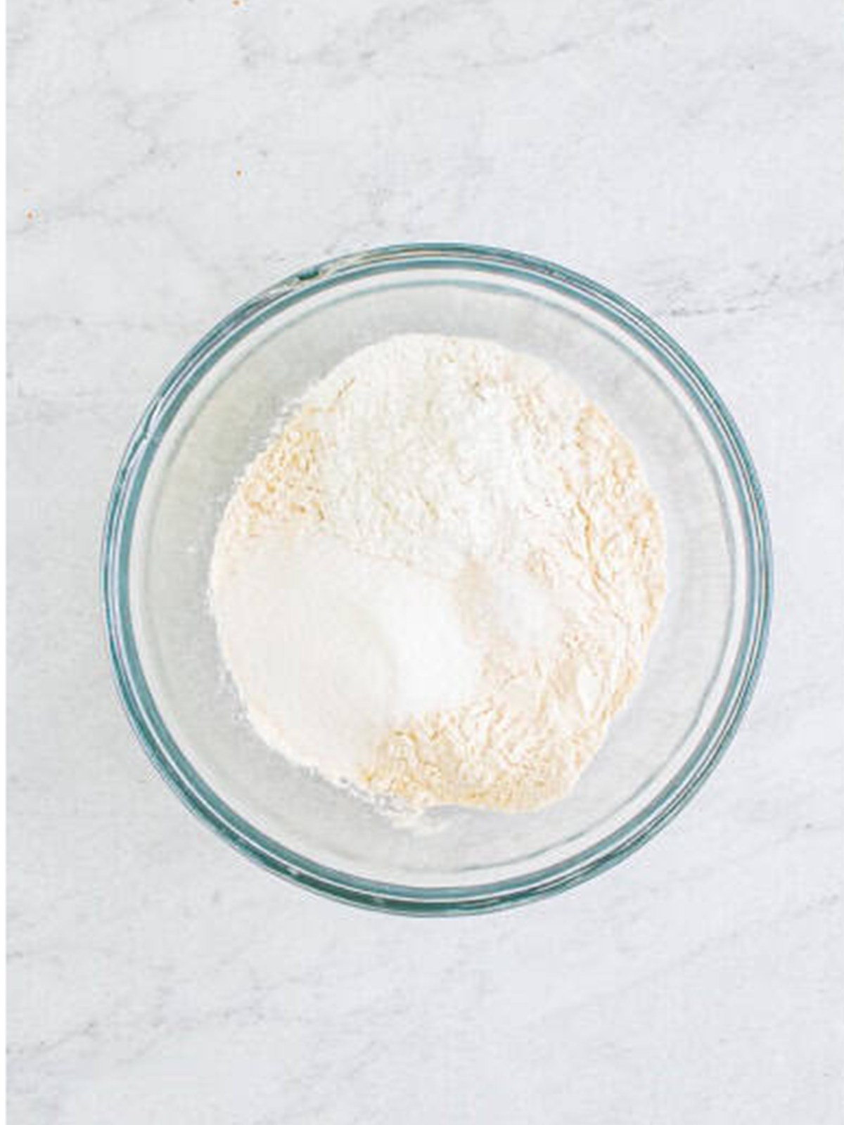 Flour, baking powder, salt, and sugar in a bowl for Buttermilk Pancakes.