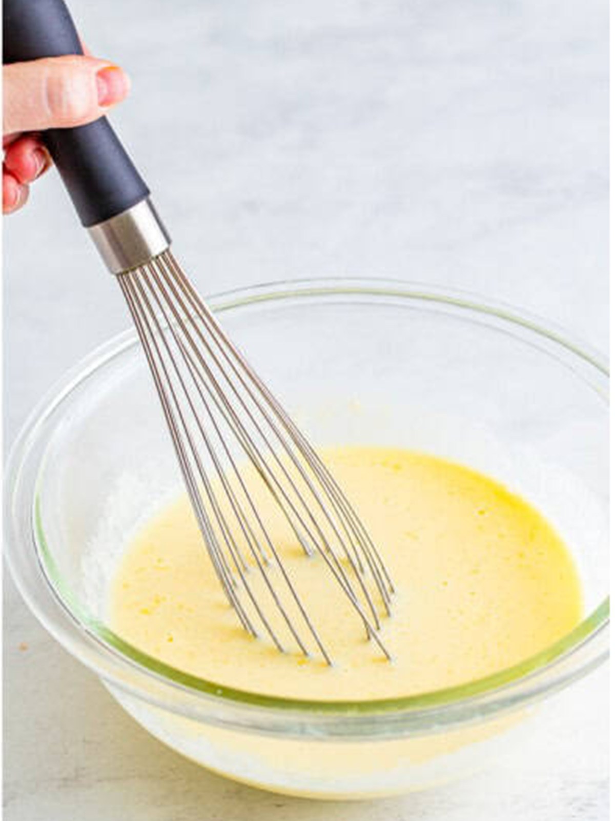 Whisking buttermilk, egg, butter, and vanilla for Buttermilk Pancakes.