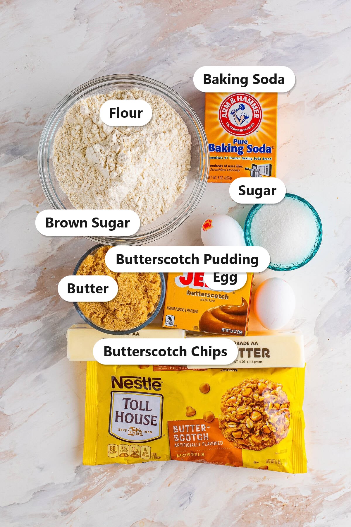 Labeled ingredients for butterscotch cookies including flour, baking soda, sugar, brown sugar, egg, butterscotch pudding, butter, and butterscotch chips.