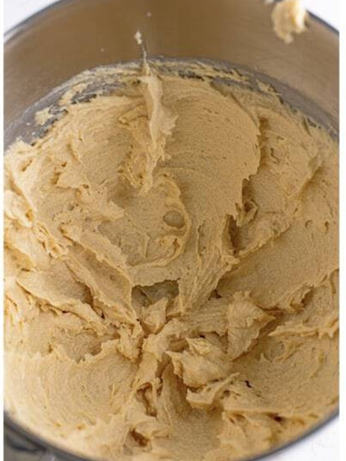 Butter and sugars creamed together in a mixing bowl for butterscotch cookies.