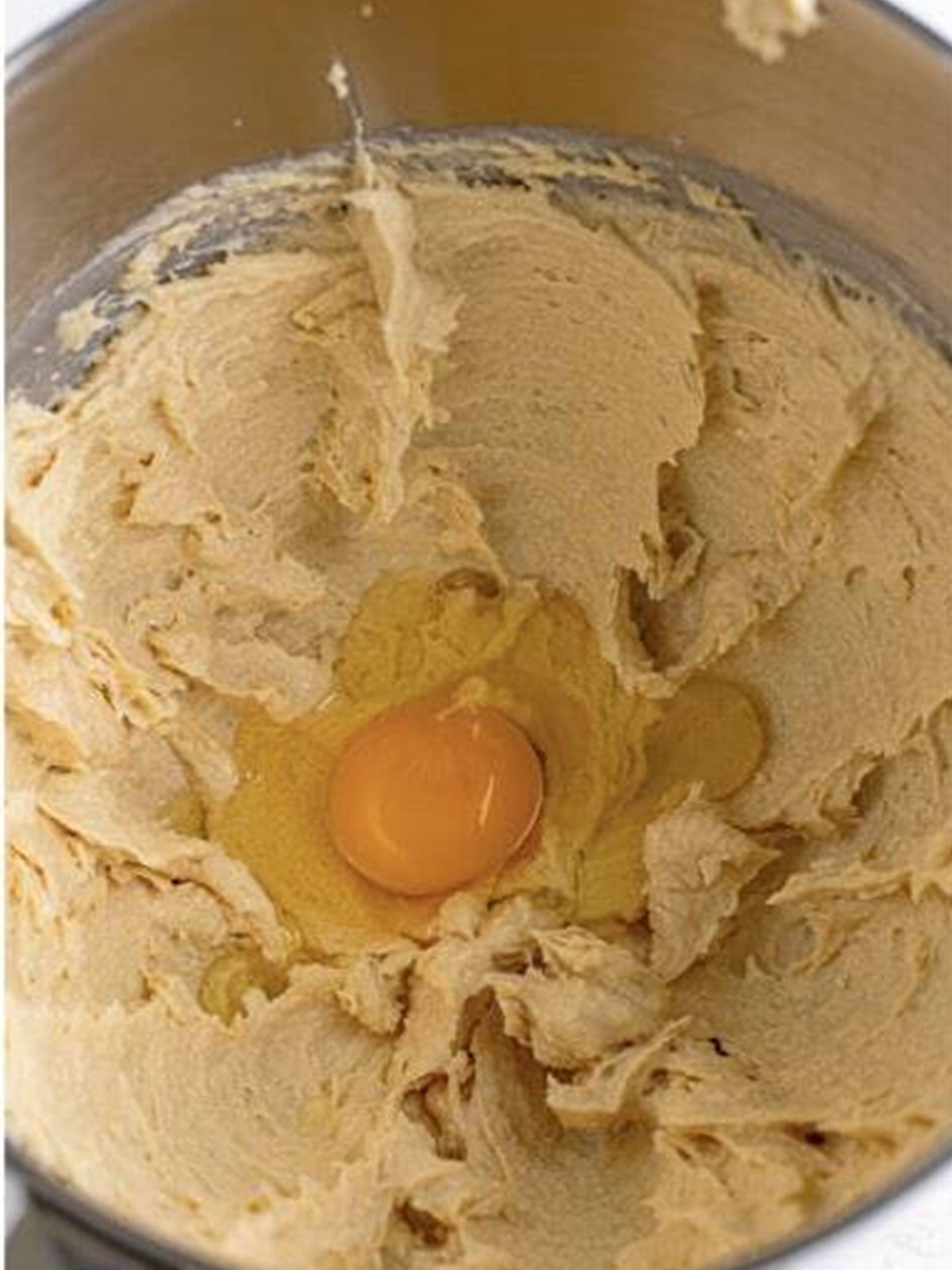 Eggs added to the creamed butter and sugar for butterscotch cookie dough.