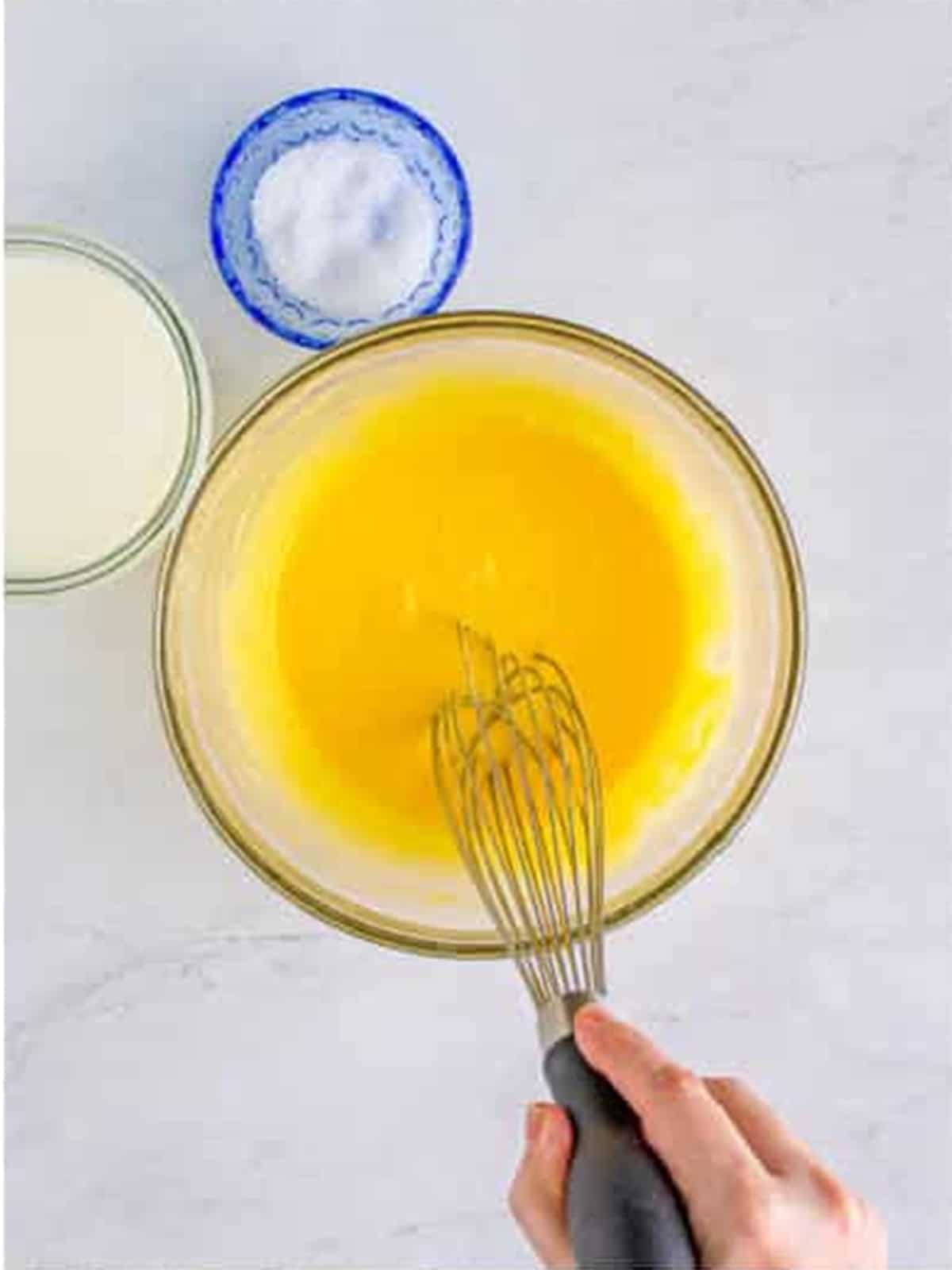 Whisking egg yolks and cornstarch in a bowl.