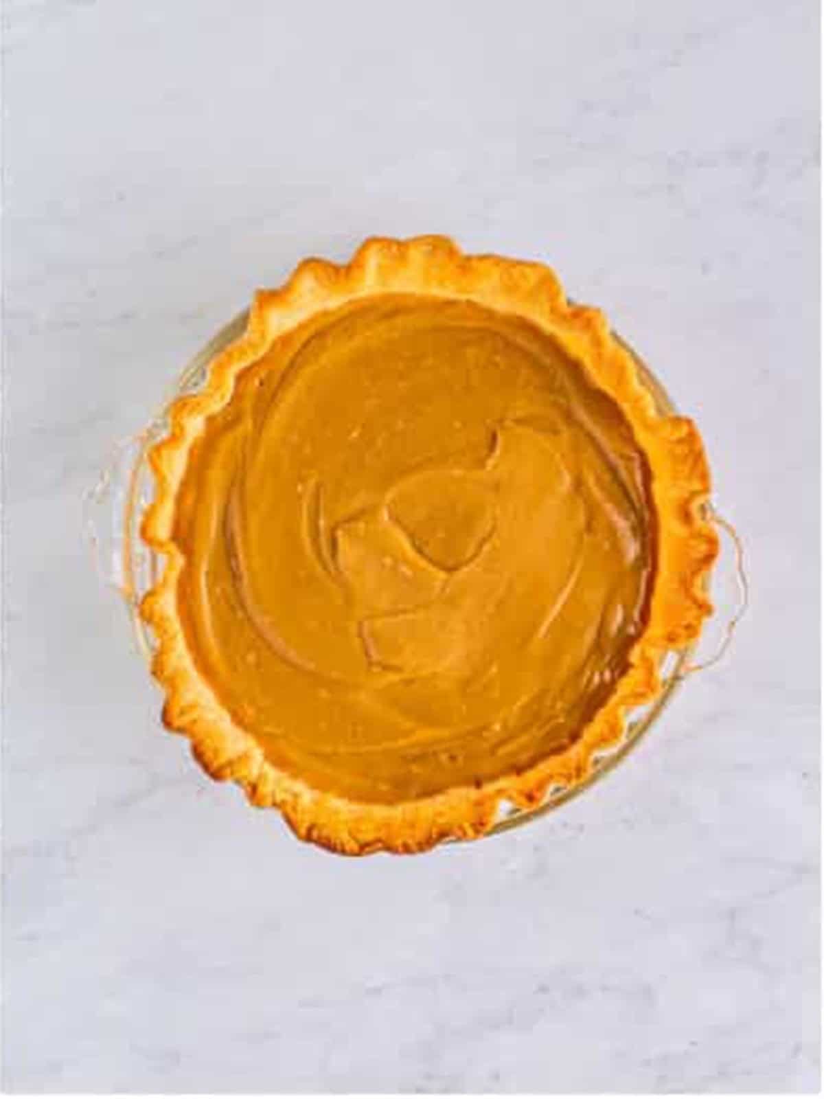 Butterscotch custard poured into a baked pie crust.