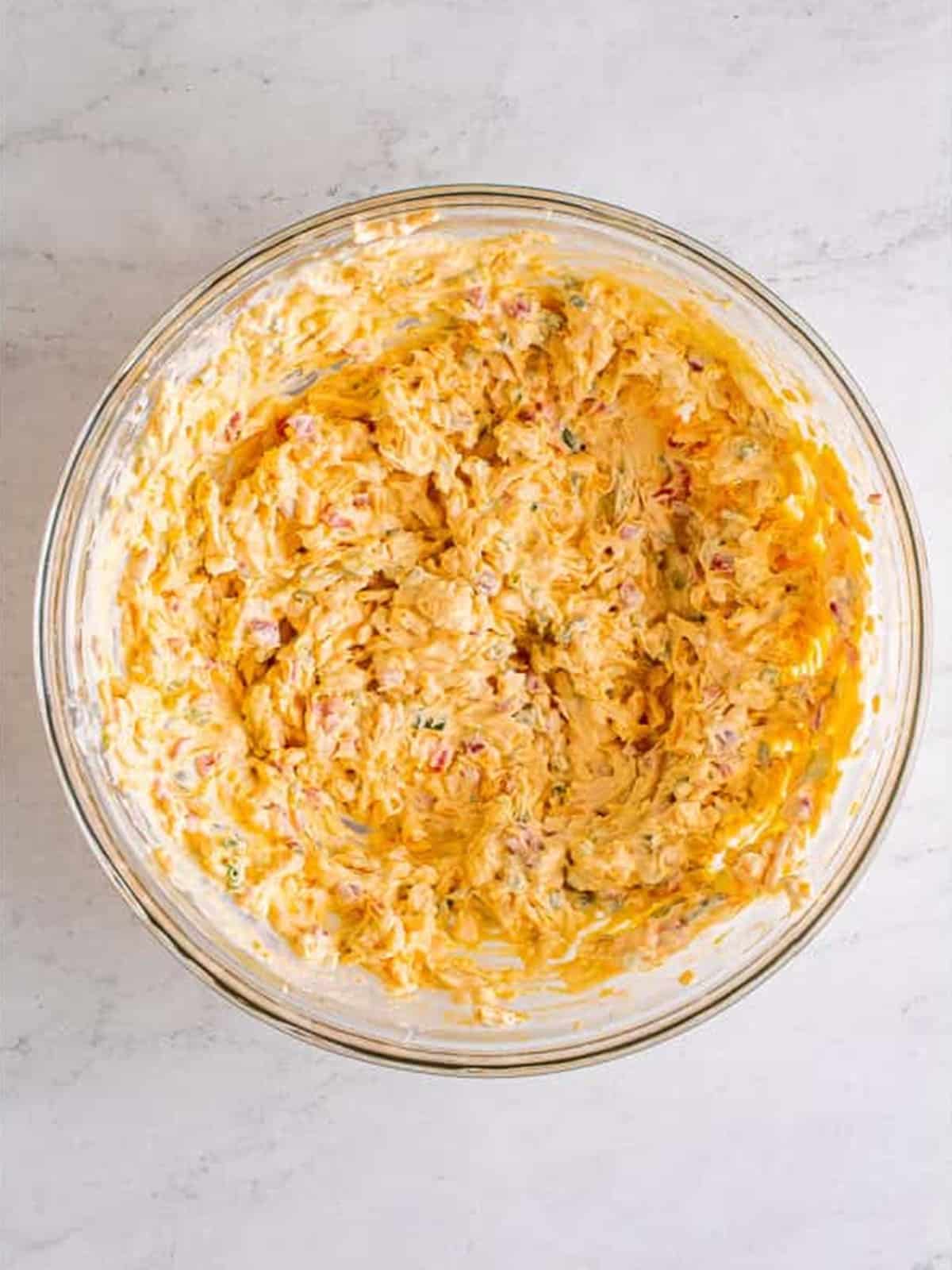 Creamy pimento cheese mixed together in a bowl.