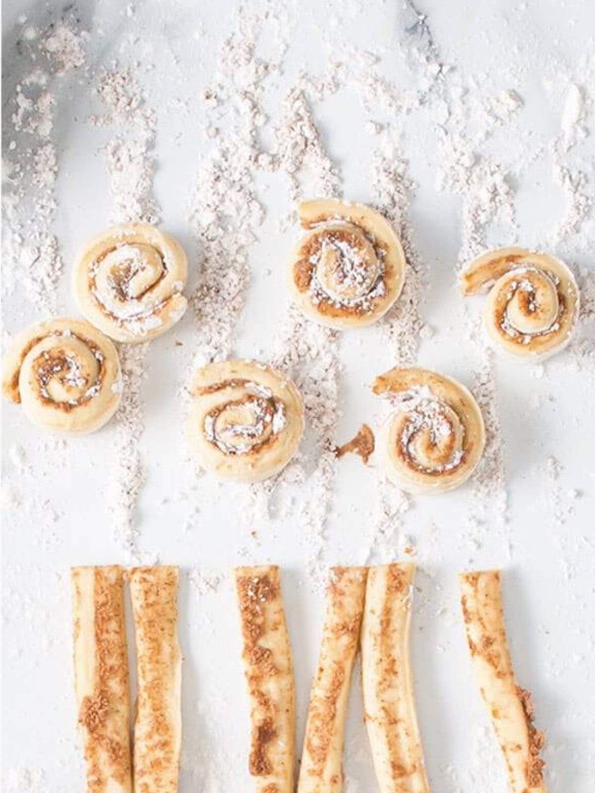 Dough strips rolled into mini cinnamon rolls.