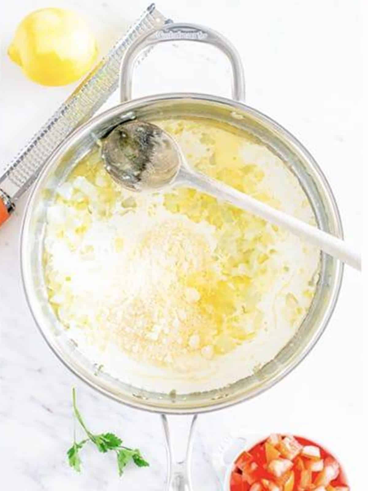 Heavy cream, lemon zest, and Parmesan whisked into the skillet for Cajun Chicken Pasta.