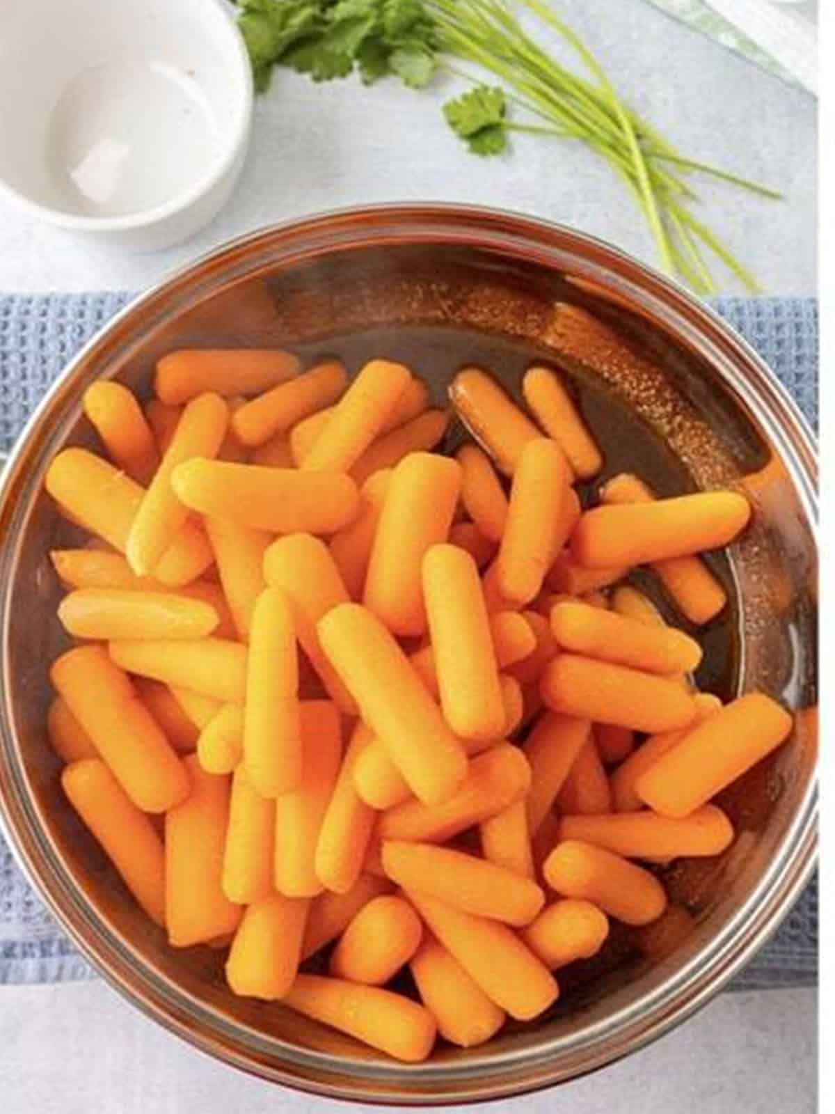 Drained baby carrots returned to the pan with the brown sugar glaze.