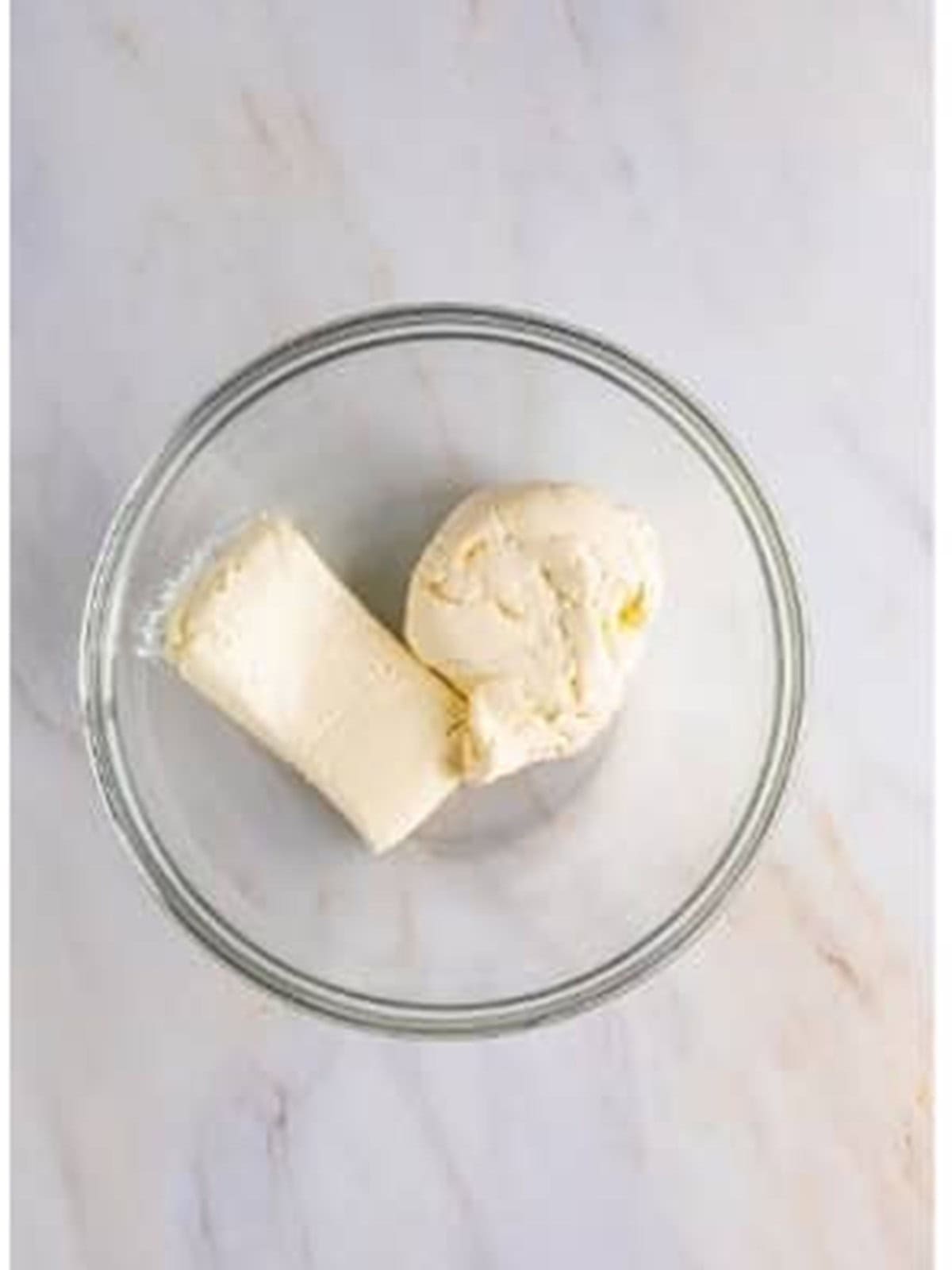 Ricotta and cream cheese in a bowl for cannoli pie filling.