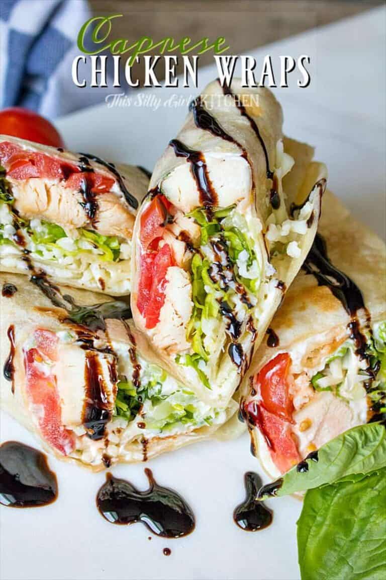 Stacked caprese chicken wraps cut in half showing chicken, tomato, basil, and balsamic glaze.