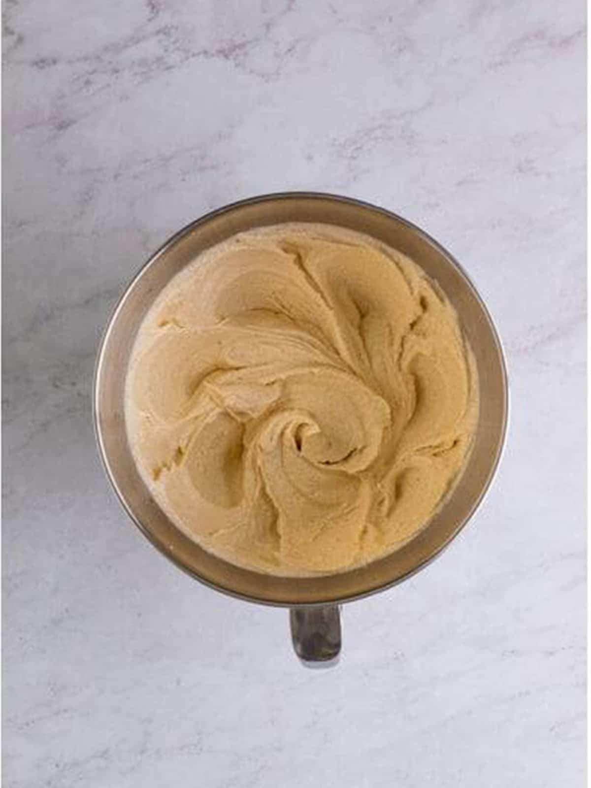 Butter, oil, granulated sugar, and brown sugar creamed together in a stand mixer for caramel cake batter.