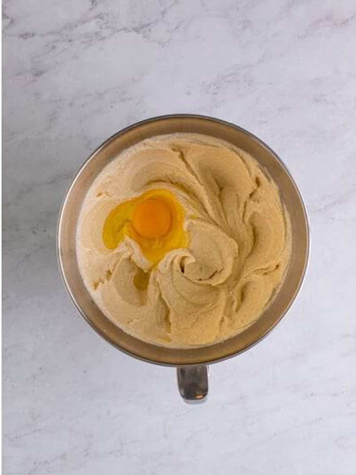 Eggs beaten into the caramel cake batter one at a time.