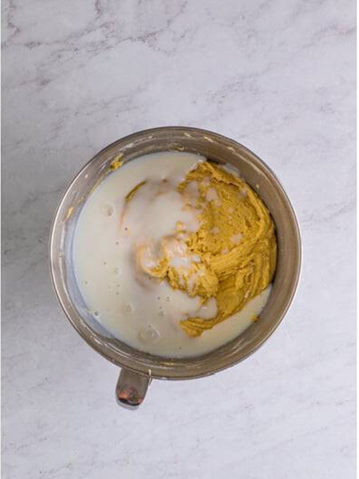 Buttermilk added to the caramel cake batter, alternating with the dry ingredients.