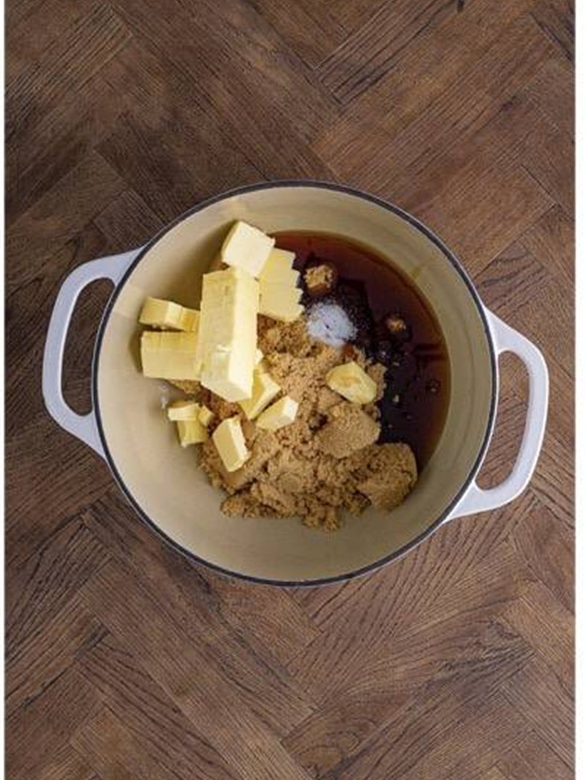 Brown sugar, butter, corn syrup, and salt added to a dutch oven to make caramel.