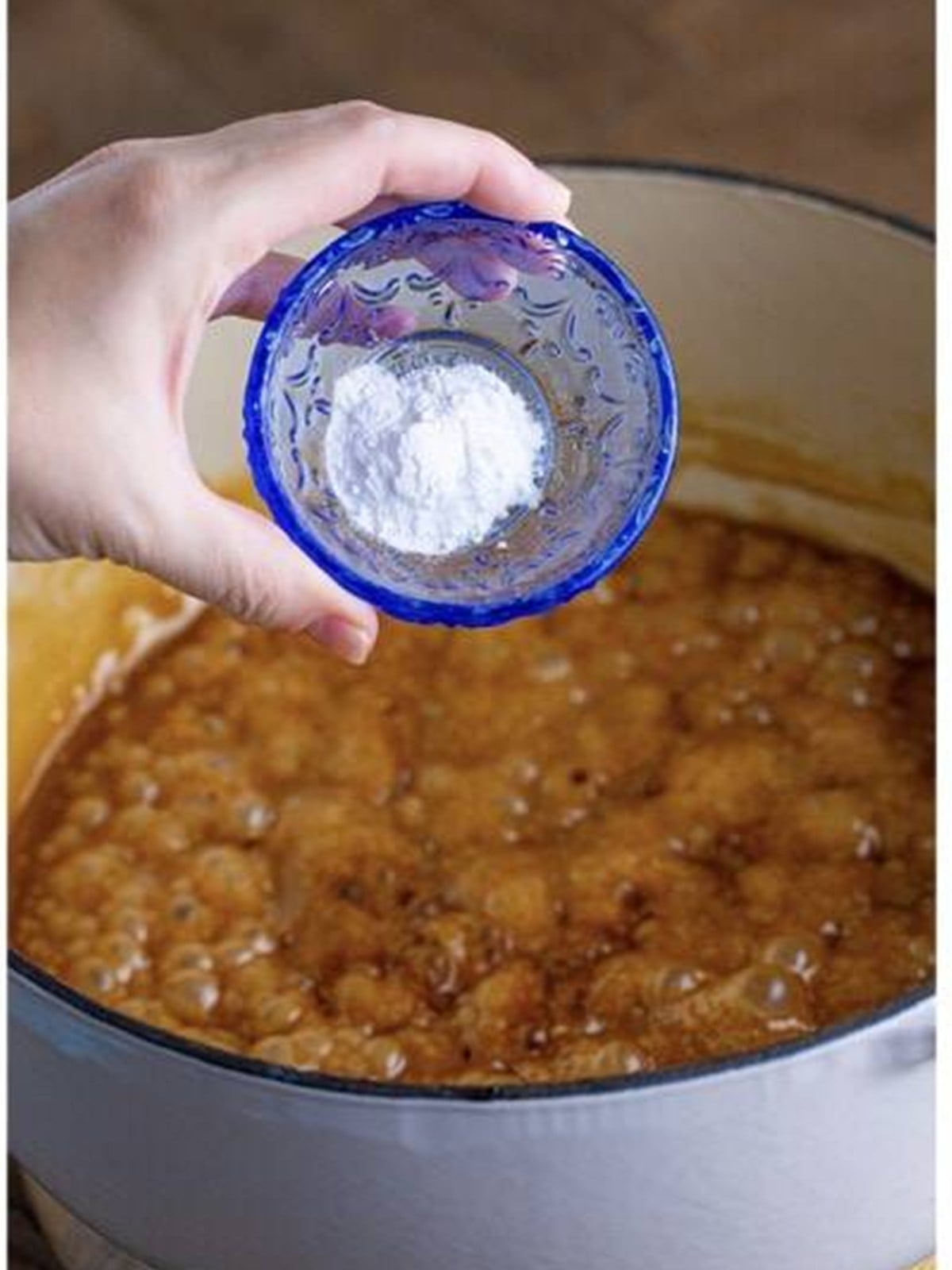 Stirring vanilla and baking soda into the hot caramel.