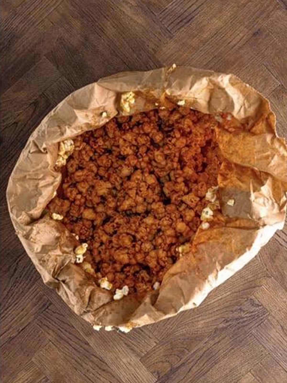 Caramel poured over popcorn and tossed to coat.