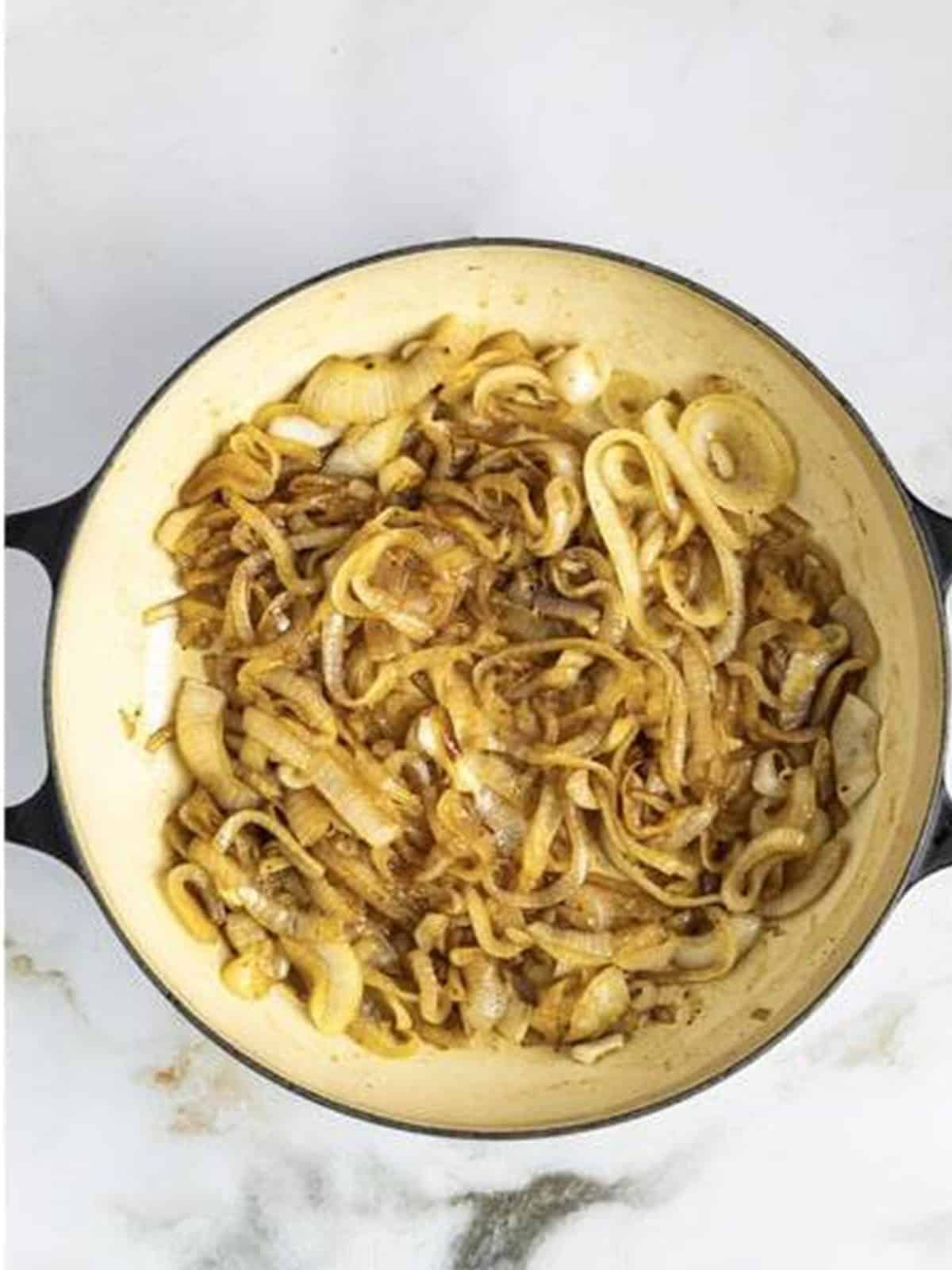 Glossy browned Caramelized Coca-Cola Onions finished in the skillet.