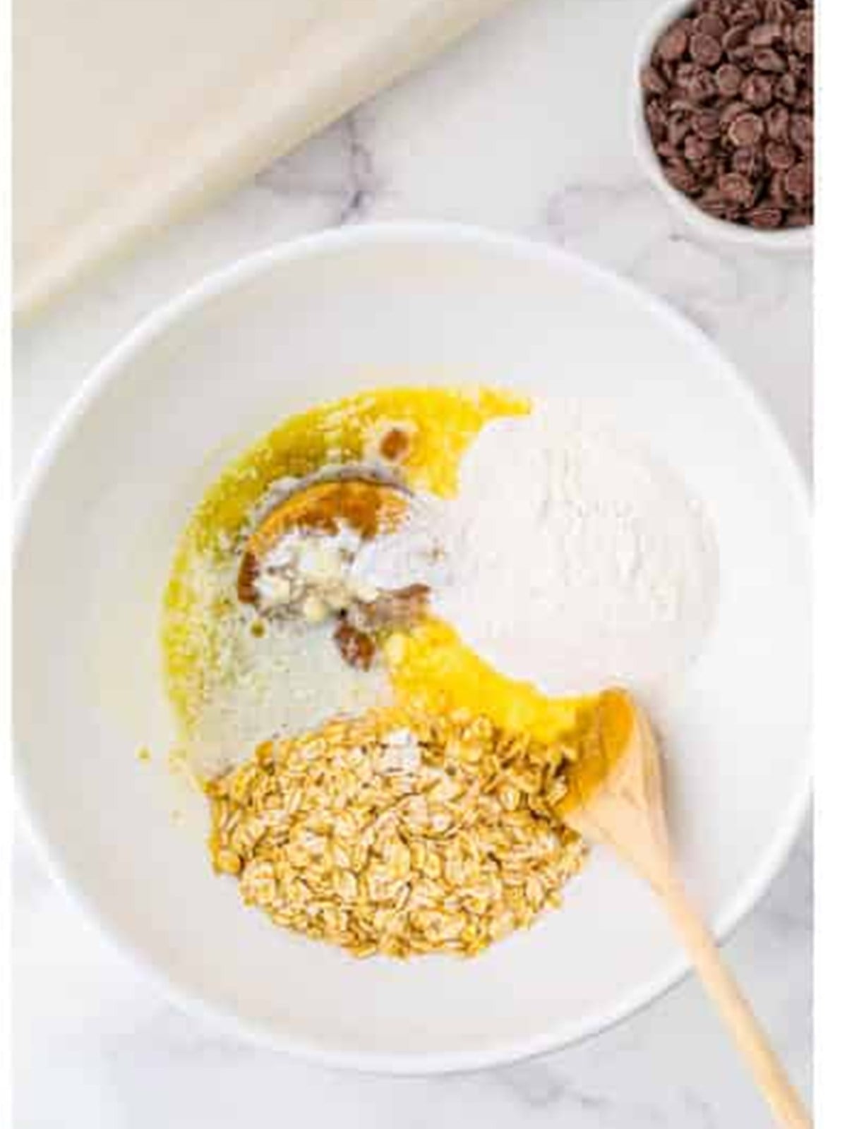 Flour, oats, melted butter, and brown sugar combined in a bowl for the Carmelitas oat crust.