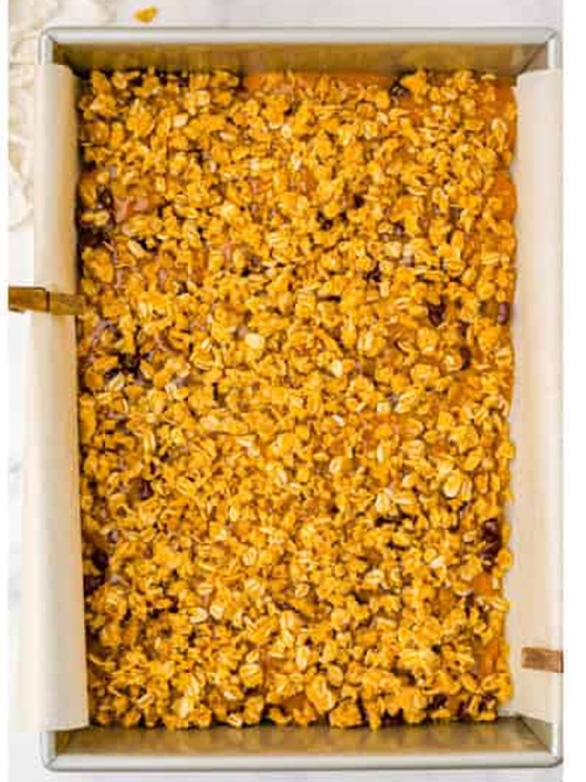Remaining oat crumb mixture sprinkled over the caramel layer before baking Carmelitas.