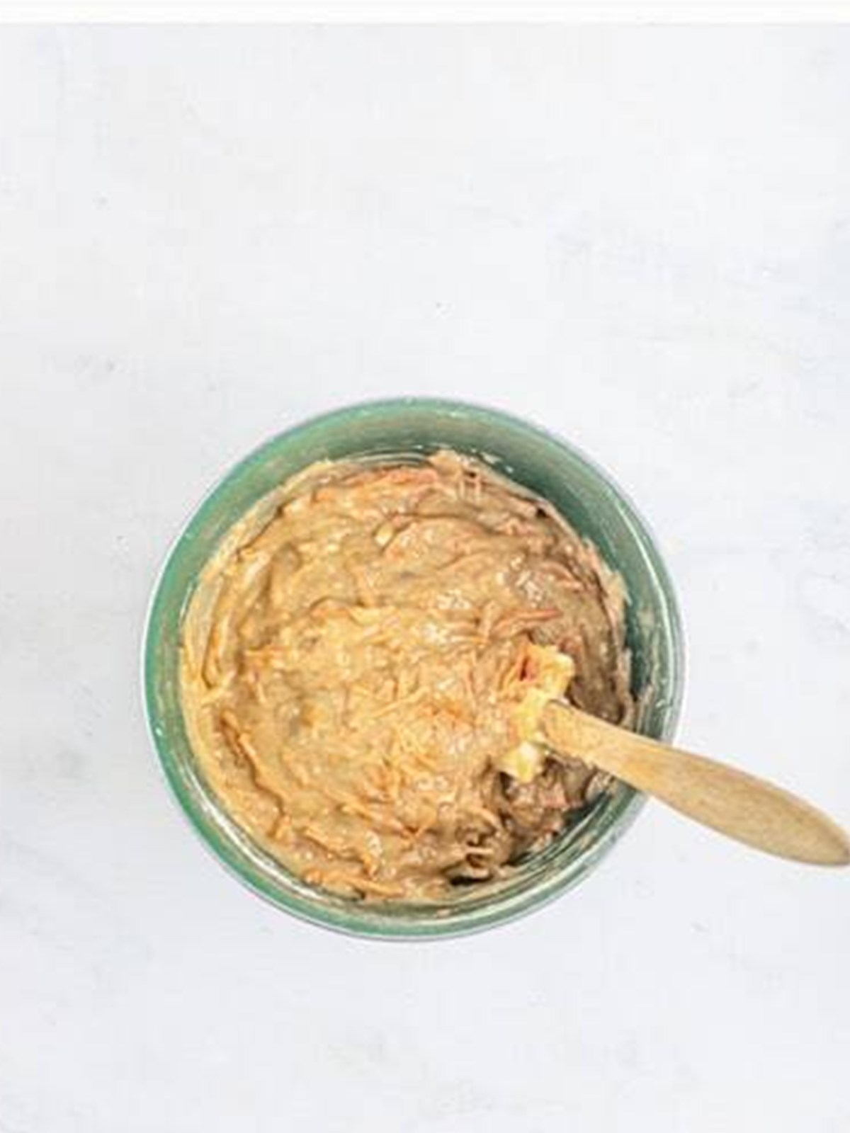 Grated carrots folded into the finished carrot bundt cake batter.