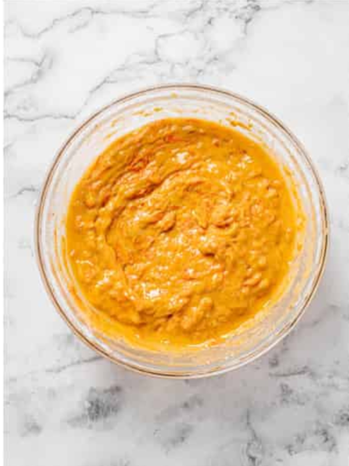 Grated carrots and walnuts folded into the carrot loaf cake batter.