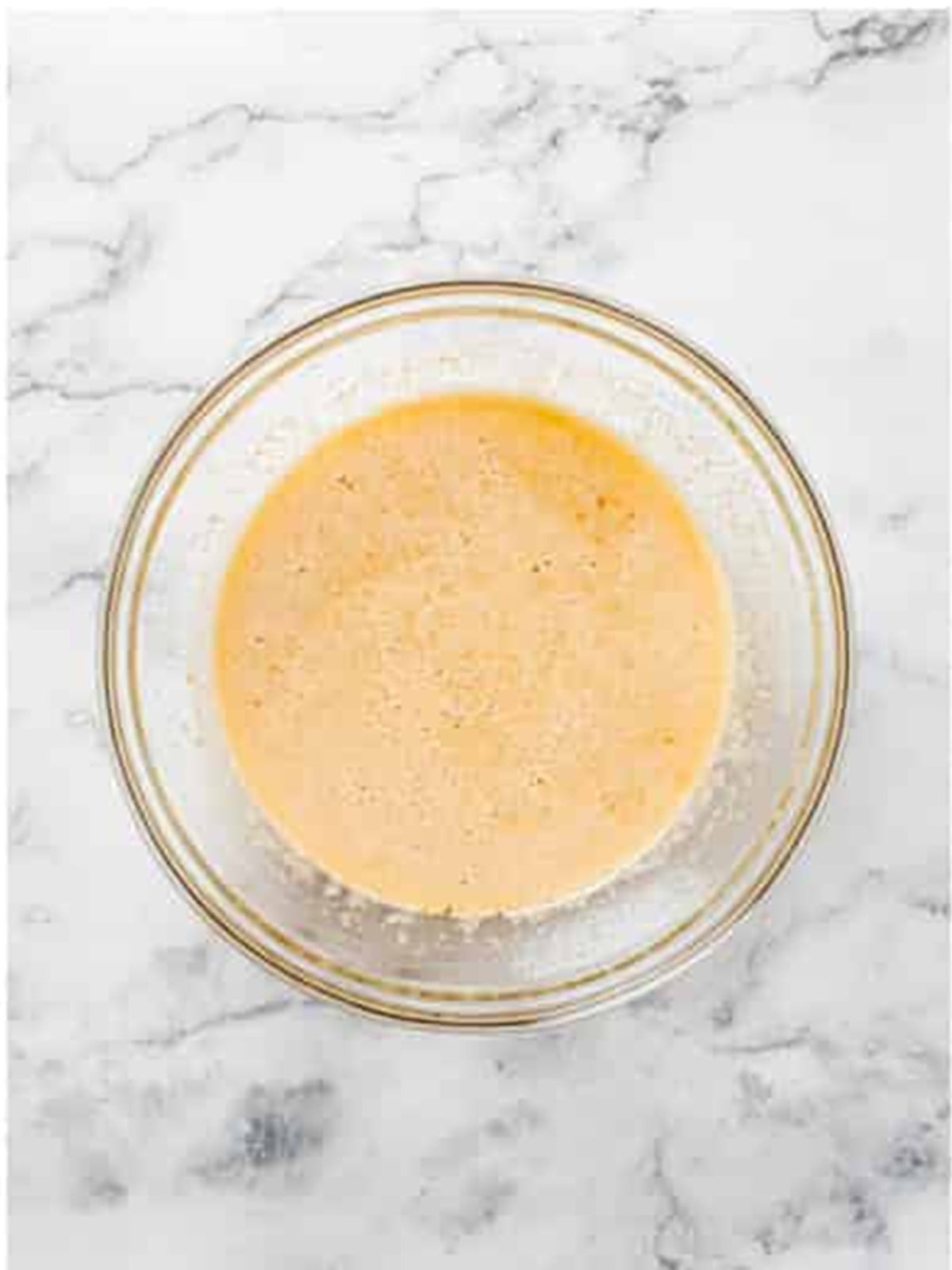 Eggs, melted butter, sugars, and vanilla whisked smooth in a glass bowl.