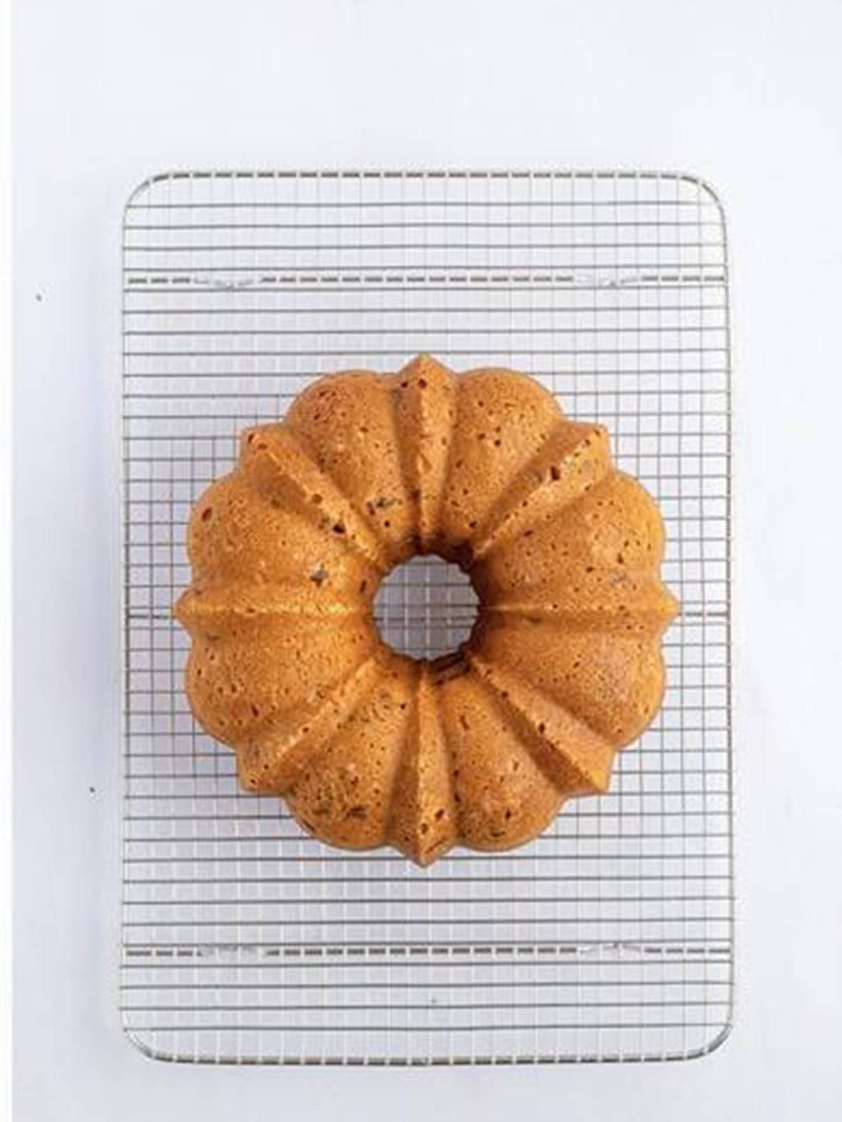 Golden baked chocolate chip bundt cake cooling on a wire rack.
